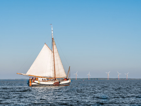 People sailing on traditional sail barge tjalk on Lake Markermeer, Netherlands