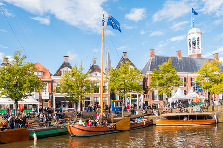 DOKKUM, NETHERLANDS - SEP 9, 2017: Quayside with people and historic ships in old harbour during event Admiralty Days, Dokkum, Friesland, Netherlandsのeditorial素材
