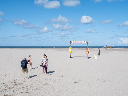 People taking photo on North Sea beach of West Frisian island Schiermonnikoog, Netherlandsのeditorial素材
