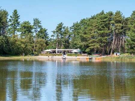 Pond with restaurant, beach and people enjoying summer on Schiermonnikoog, Netherlandsのeditorial素材