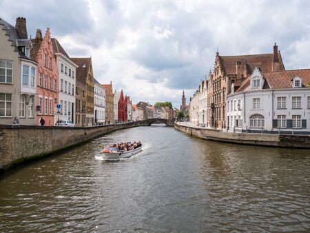 Boat tour on historic Spiegelrei canal in old town of Bruges, Belgiumのeditorial素材
