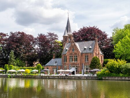 Castle della Faille along Minnewater lake in old town of Bruges, Belgiumのeditorial素材