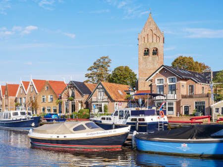 Boats, houses and church tower in old town of Grouw, Friesland, Netherlandsのeditorial素材