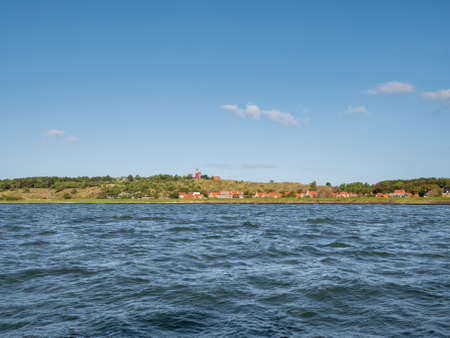 West Frisian island Vlieland with Vuurduin lighthouse on Vuurboetsduin and East-Vlieland town from Wadden Sea, Friesland, Netherlandsの写真素材