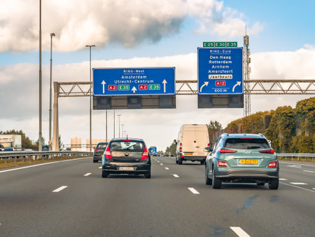 Cars and route information on overhead gantry, motorway A2 at exit to A12, traffic junction...