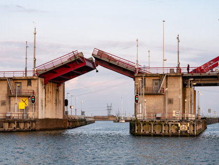 Moveable part of road bridge Schellingwouderbrug opening for boats on Buiten IJ river, Amsterdamのeditorial素材