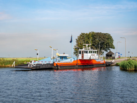 Motorised cable pontoon ferry boat between Zwartsluis and Genemuiden on Zwarte Water river, Overijssel, Netherlandsのeditorial素材