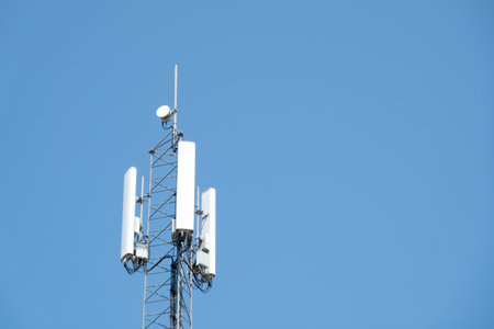 Top of telecommunication tower against blue sky, Netherlandsの写真素材