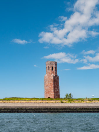 Former church tower Plompetoren on dike at Oosterschelde, Easter Scheldt, estuary, Zeeland, Netherlandsの写真素材