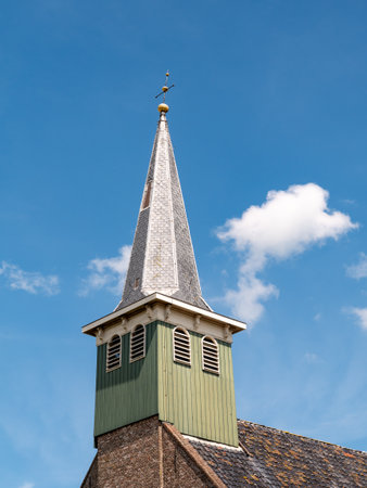 Wooden tower with constricted spire of Haghakerk, church in center of Heeg, Friesland, Netherlandsの写真素材