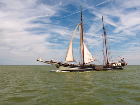 Clipper and brown fleet charter ship sailing on IJsselmeer lake in the Netherlands on a sunny summer dayのeditorial素材