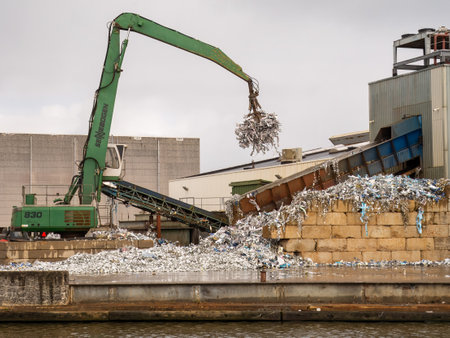 Tin scrap is collected with crane for detinning in a tin recycling factory, Leeuwardenのeditorial素材
