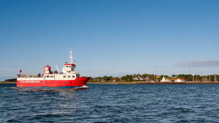 Ferry boat TunÃ¸faergen with passengers approaching harbour of TunÃ¸ island, Midtjylland, Denmarkのeditorial素材