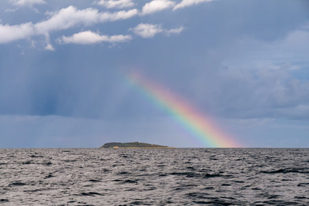 Rainbow and rain clouds, stormy skies over Hjelm Island, Kattegat, Denmarkの写真素材