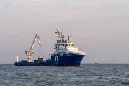 Offshore support vessel Aquarius-G operating in Elbe River estuary, Germany, near North Sea