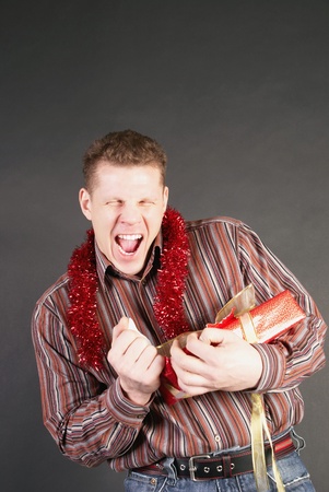 Man opened out a gift and glad                 の写真素材
