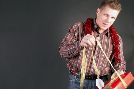 A man opens a gift in the beautiful packing                   の写真素材