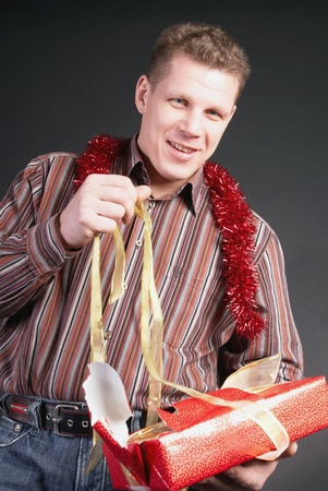 A man unties the ribbons of gift                  の写真素材