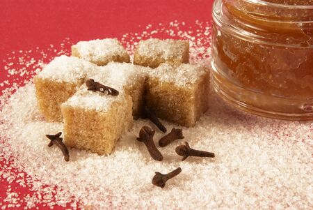 Body scrub with brown sugar crystals, spicinesses, on a red background                       の写真素材