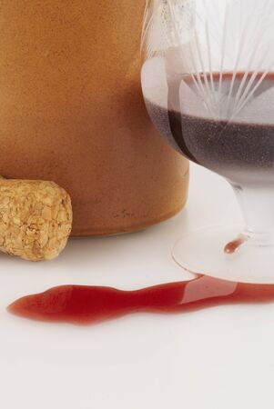 Glass with red wine, cork and clay bottle                       の写真素材