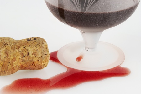 Poured out red wine, glass and winy cork                      の写真素材