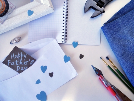 White frame, a compass, a shell on a light background and a postcard to the day of the fatherの写真素材