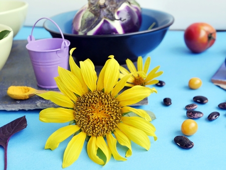 Decorative autumn composition of fruits, vegetables, spices, flowers on a light blue background and gray canvas, top viewの写真素材