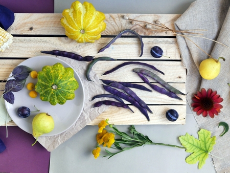 ?olorful vegetables, fruits, flowers and leaves on the surface of different textures, seasonal decorative composition, autumn, summer still life, top viewの写真素材