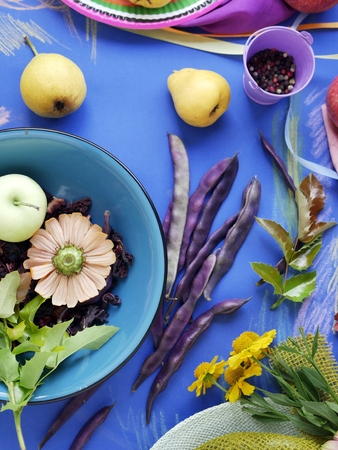 Seasonal decorative still life of bright fruits, vegetables, leaves and spices on toned blue paper, painted with pastels, top view. The concept of the season is summer, harvest, lifestyleの写真素材
