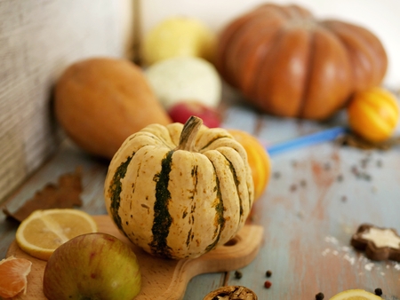 Pumpkin, seasonal vegetables, wooden table