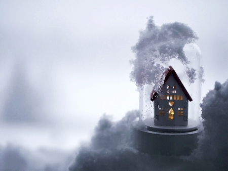 Toy little white house with illumination in the snowの写真素材