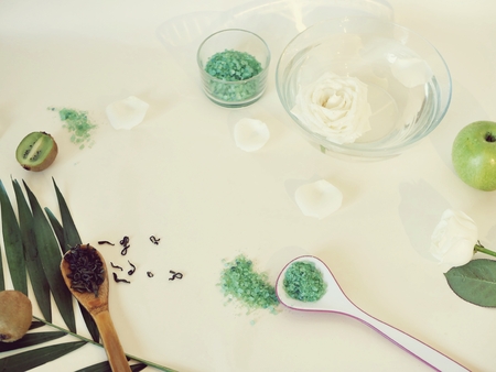 White roses, petals, sea salt, light table, top viewの写真素材