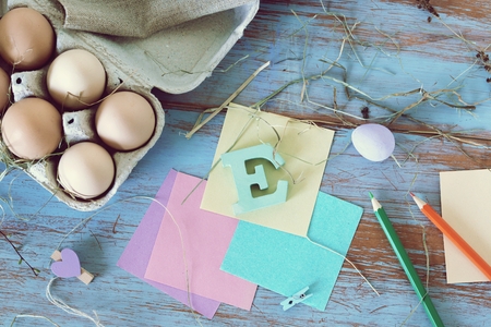 Eggs, quail, easter decor on a blue wooden table