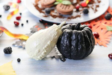 Halloween food, dessert with chocolate, pumpkins, ice cream and jelly wormsの写真素材