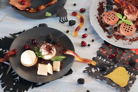 Halloween food, autumn leaves and dessert with chocolate, ice cream