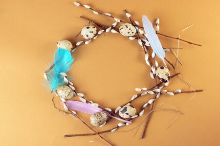 Easter decoration for the holiday, a wreath of eggs, feathers, willow twigs, top view
