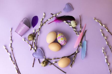 Easter decoration for the holiday, a wreath of eggs, feathers, willow twigs, top viewの写真素材