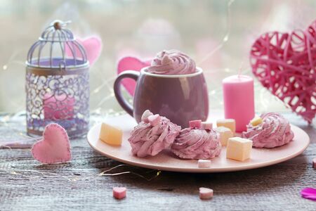 Cup of coffee with meringues and marshmallows, Turkish delight on a plate, hearts, illumination,...