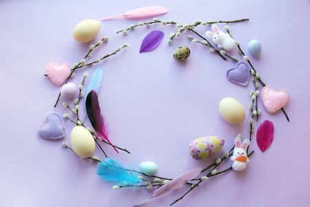 Easter decoration for the holiday, a wreath of eggs, feathers, willow twigs, top view
