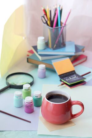 School stationery, books, cup of tea on the table, home schooling concept, part of the interior children's room, back to schoolの写真素材