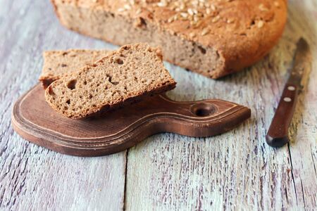 Homemade bread sliced in slices on a wooden board, healthy food, whole grain, organic product