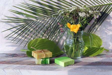 Soap, a bouquet of healing herbs in a glass jug on a wooden windowsill, natural cosmetics, the concept of a healthy lifestyle, homeliness and cleanlinessの写真素材