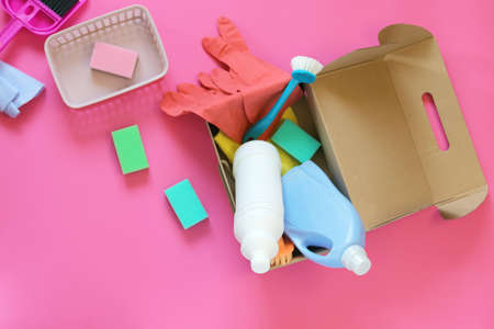 Household cleaning products in open boxes on a bright background, top view, home delivery