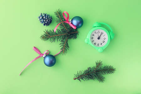 Merry Christmas, alarm clock, fir branches and toy balls on bright background, flat ley, top view, holiday time conceptの写真素材