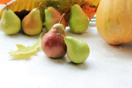 Fresh pears, autumn leaves on a wooden table, organic fruits, harvest, Thanksgivingの写真素材