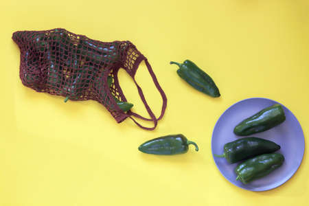 Capsicums red and green in ecological packaging brought from the market, on the table, top view, flat ley, healthy seasonal food concept, home cookingの写真素材