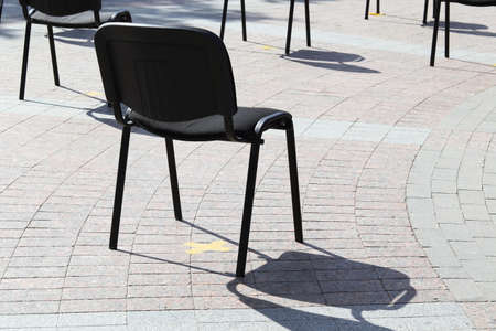 Chairs on the street are arranged in rows at a distance, keep your distance, quarantine measures,...