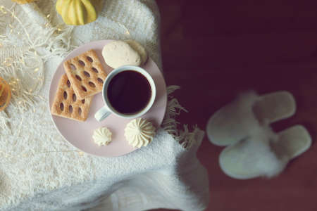 A cup of coffee, meringues, pumpkins, leaves, a warm blanket on the windowsill, slippers, the concept of home comfort, loneliness, relaxation, Thanksgiving, autumn seasonの写真素材