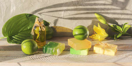Soap, limes, aromatic oil on a wooden table, natural home cosmetics, healthy lifestyleの写真素材