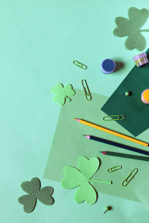 Saint Patrick's day, art materials on the table, decorative clover leaves, top view, home decoration...
